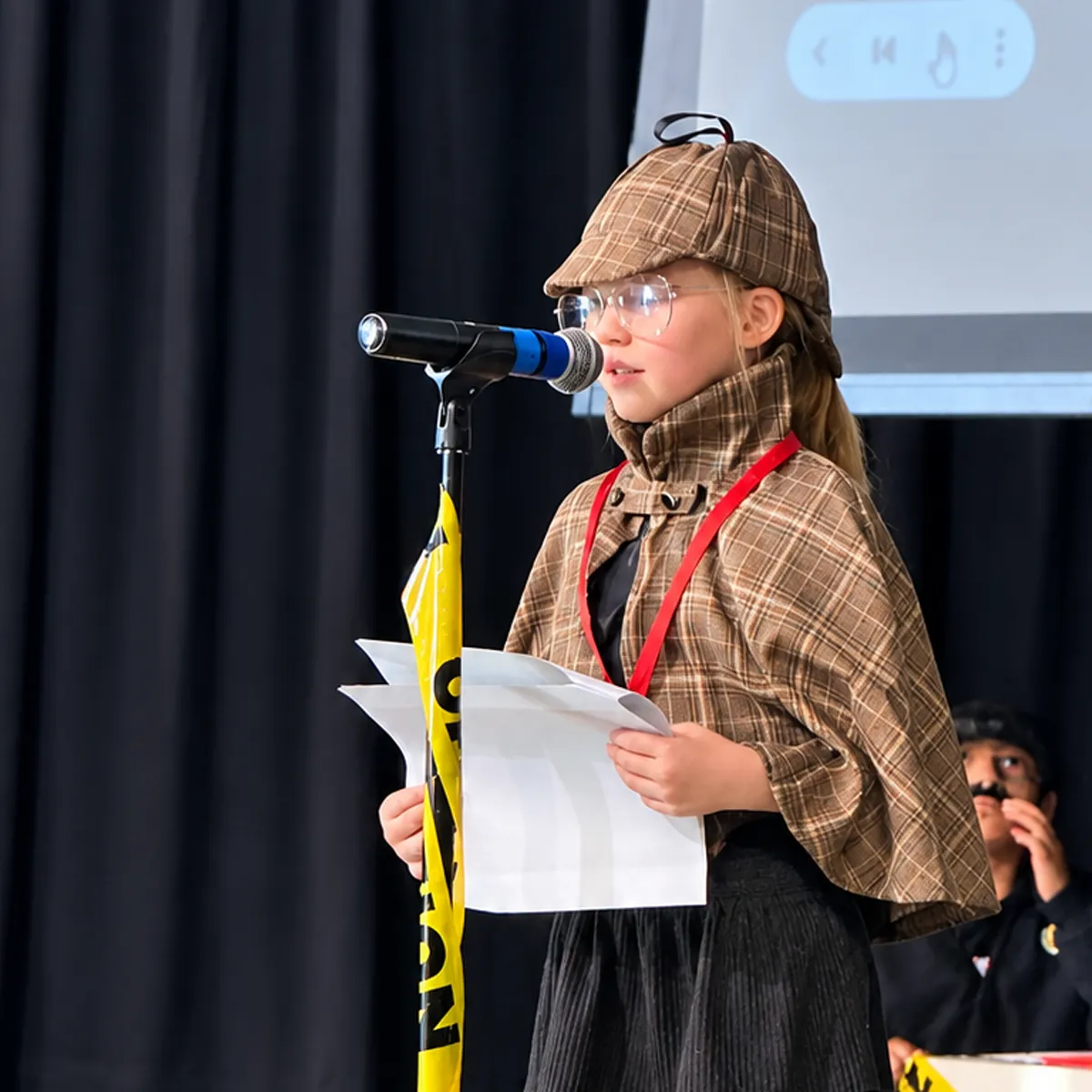 summit-elementary-finding-their-voice Summit elementary student presenting at a microphone during a school performance.