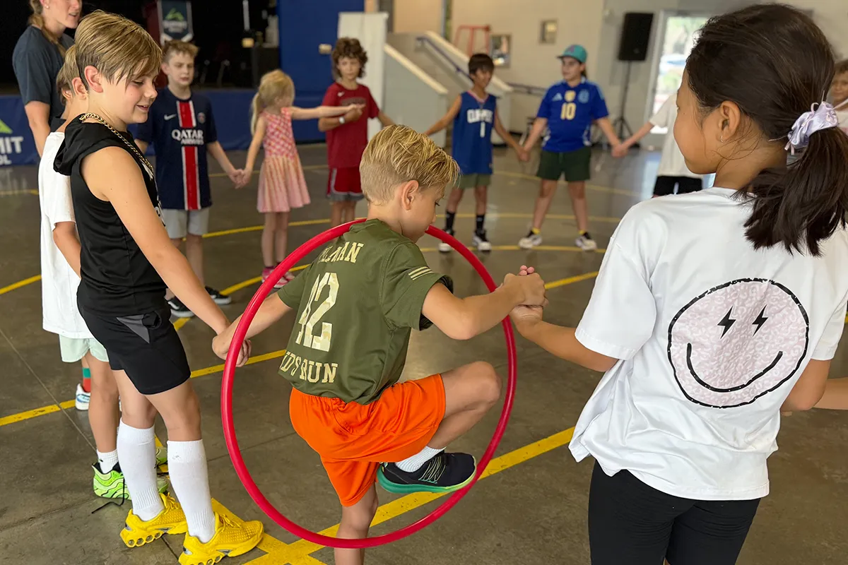 summit-elementary-physical-education-teamwork Summit School elementary students practicing coordination and teamwork during physical education.