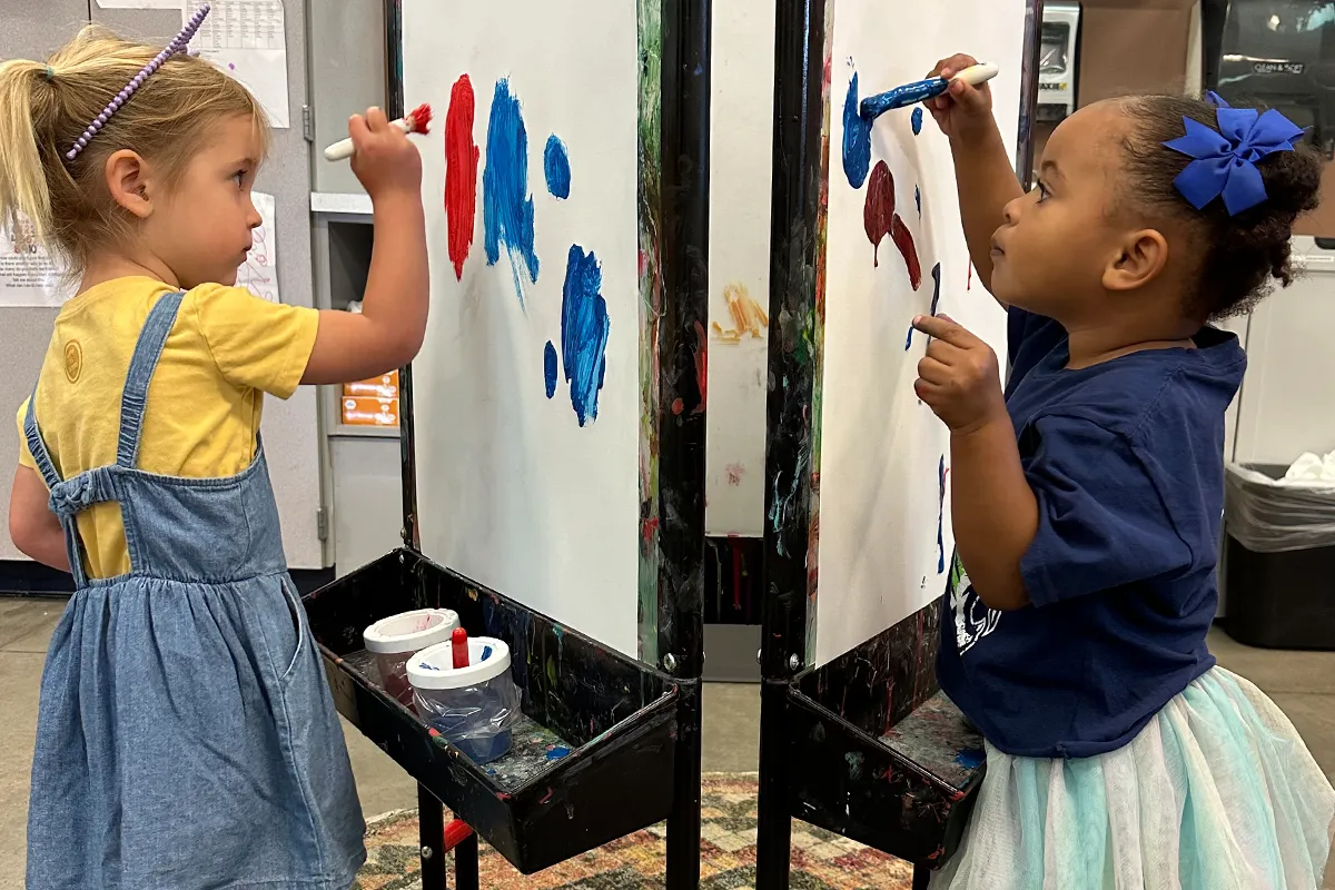 summit-preschool-art-exploration Summit preschool students exploring creativity and self-expression through painting.