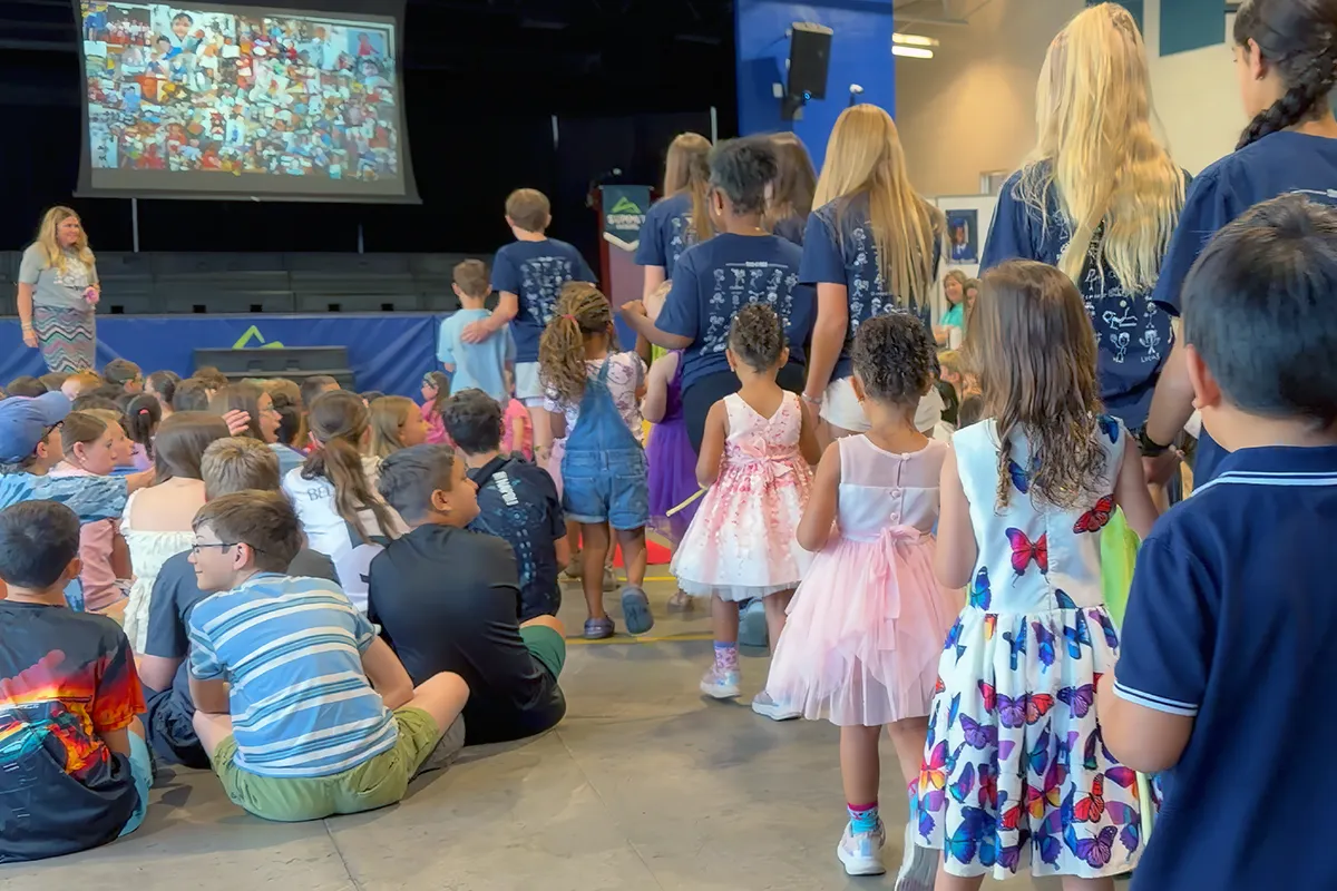 Summit preschool students participating in a school tradition alongside older students