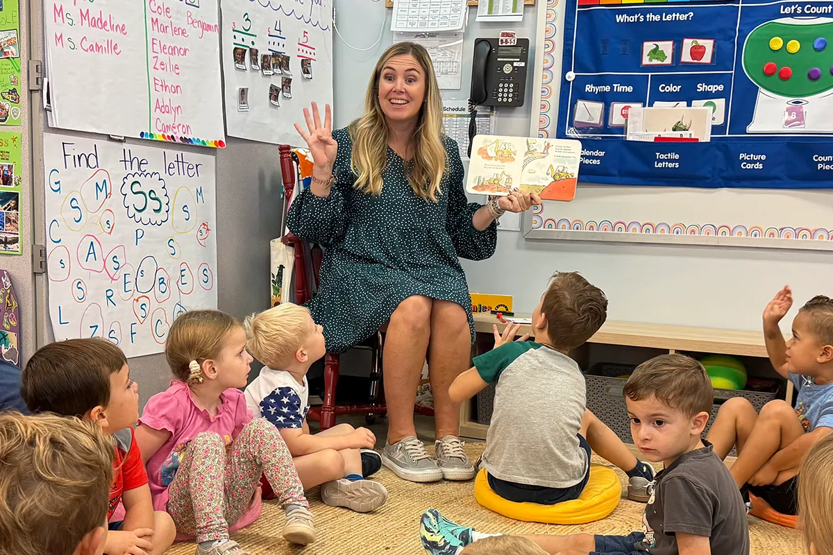 Summit School preschool teacher reading with students during an early literacy lesson