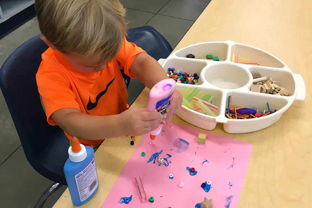Summit preschool student developing fine motor skills through a hands-on creative activity