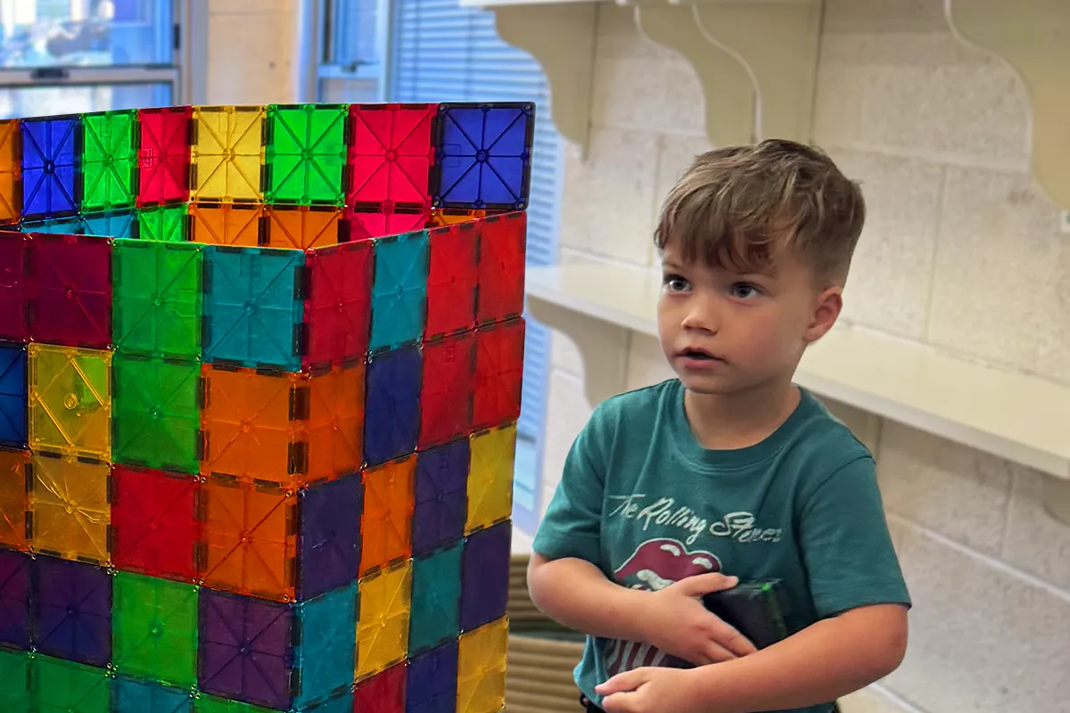Summit preschool student developing problem-solving skills through independent building