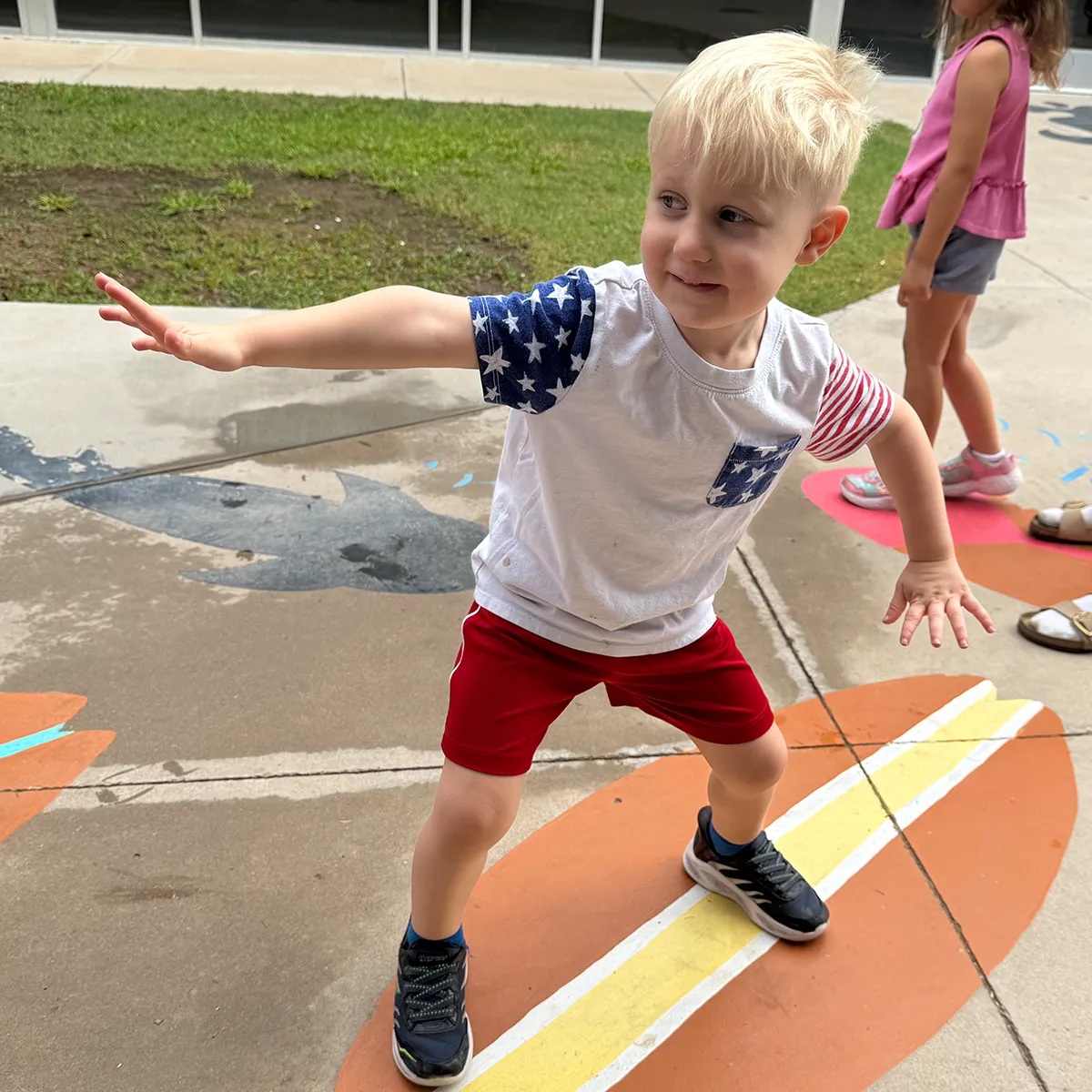 Summit preschool student practicing balance and coordination during outdoor play.