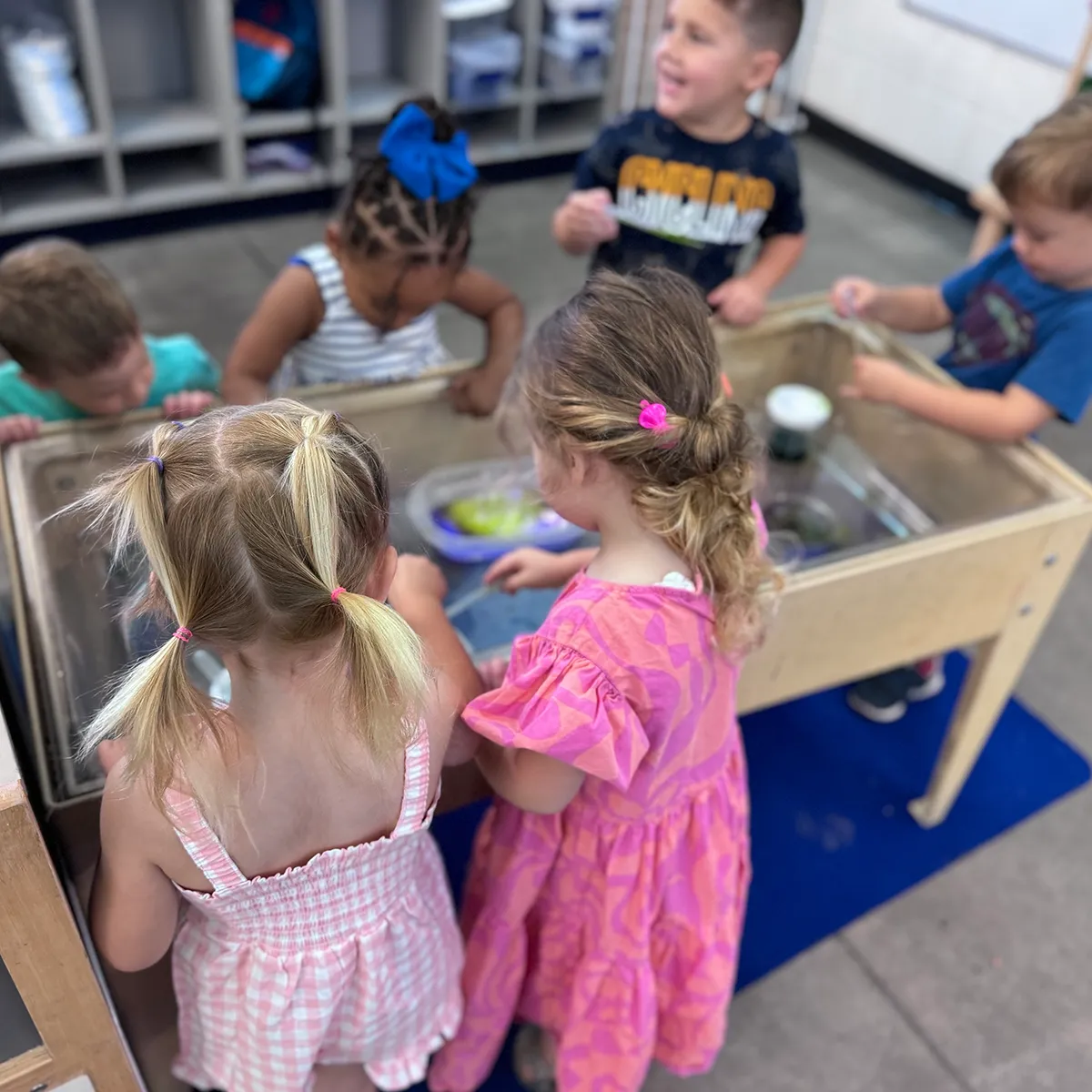 Summit preschool students exploring together through hands-on sensory learning.