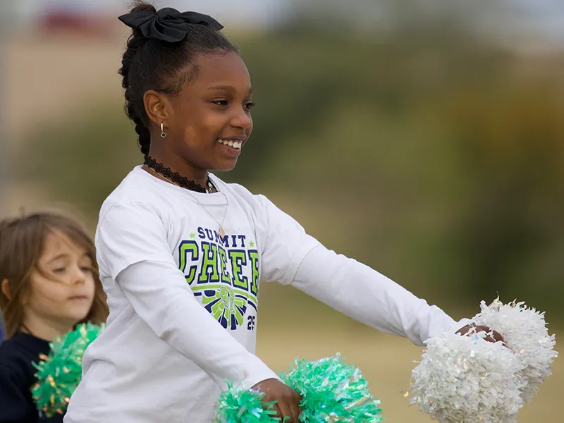 summit-school-ahwatukee-student-cheerleading School student cheerleader participating in school athletics.
