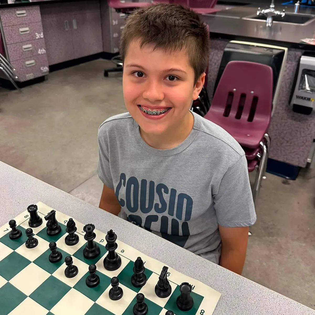 Summit School student participating in chess during an after-school enrichment class.