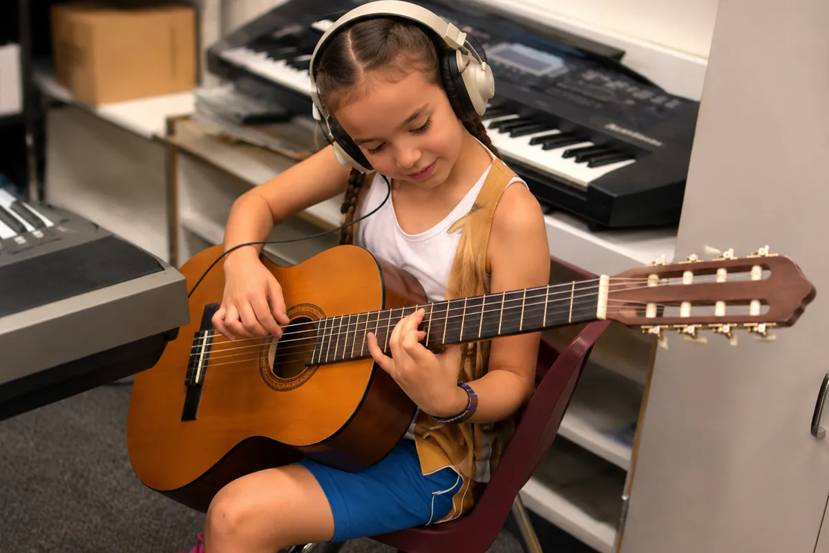 summit-elementary-suzuki-guitar Elementary student practicing guitar during Suzuki Guitar at Summit School.