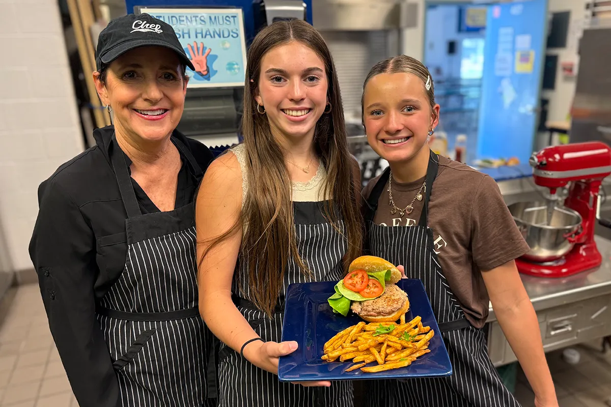 summit-middle-school-culinary-elective Summit Middle School students presenting a dish they prepared during a culinary elective.
