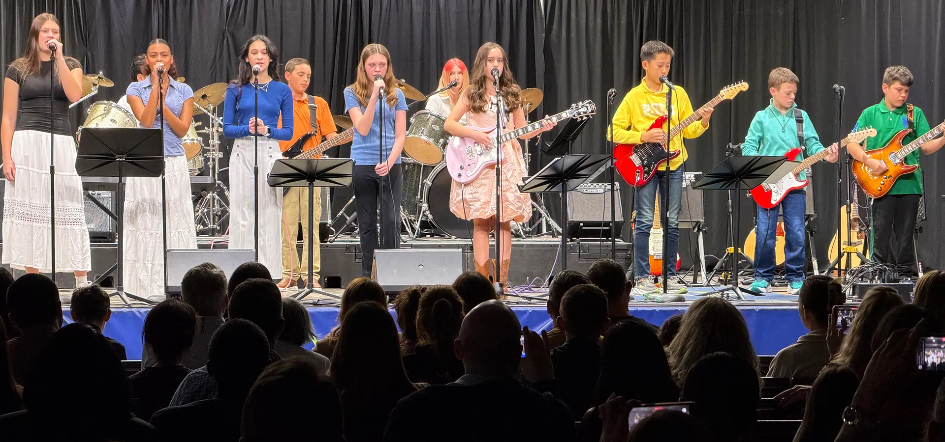 summit-middle-school-electives-rock-band-performance Summit Middle School students performing together in a rock band concert.