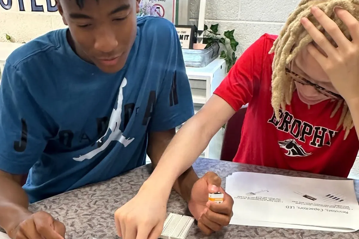 Summit middle school students collaborating on academic work across disciplines.