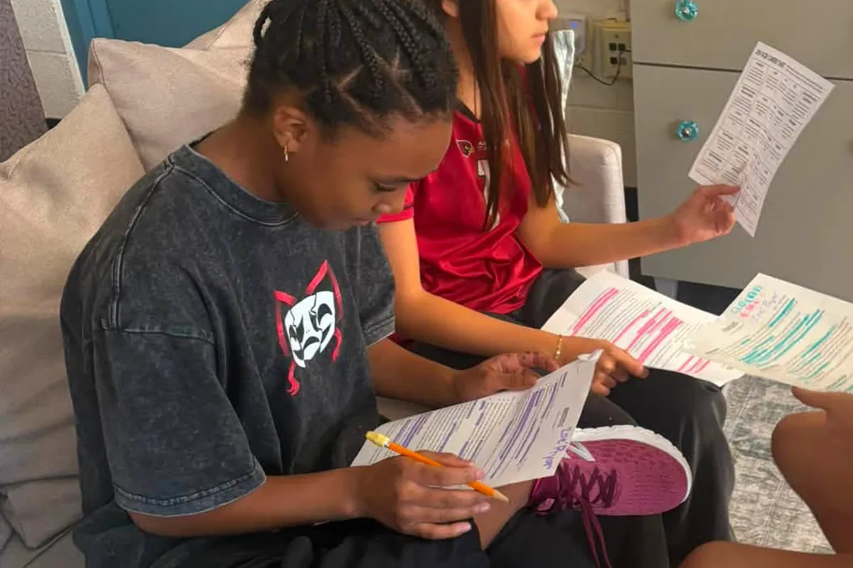 Summit middle school students reviewing and revising written work together.
