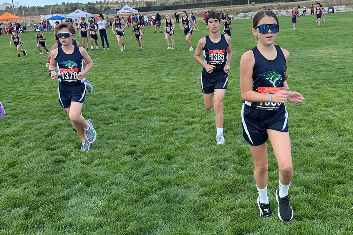 summit-school-cross-country-runners Summit School cross country runners build endurance and pace together on the course.