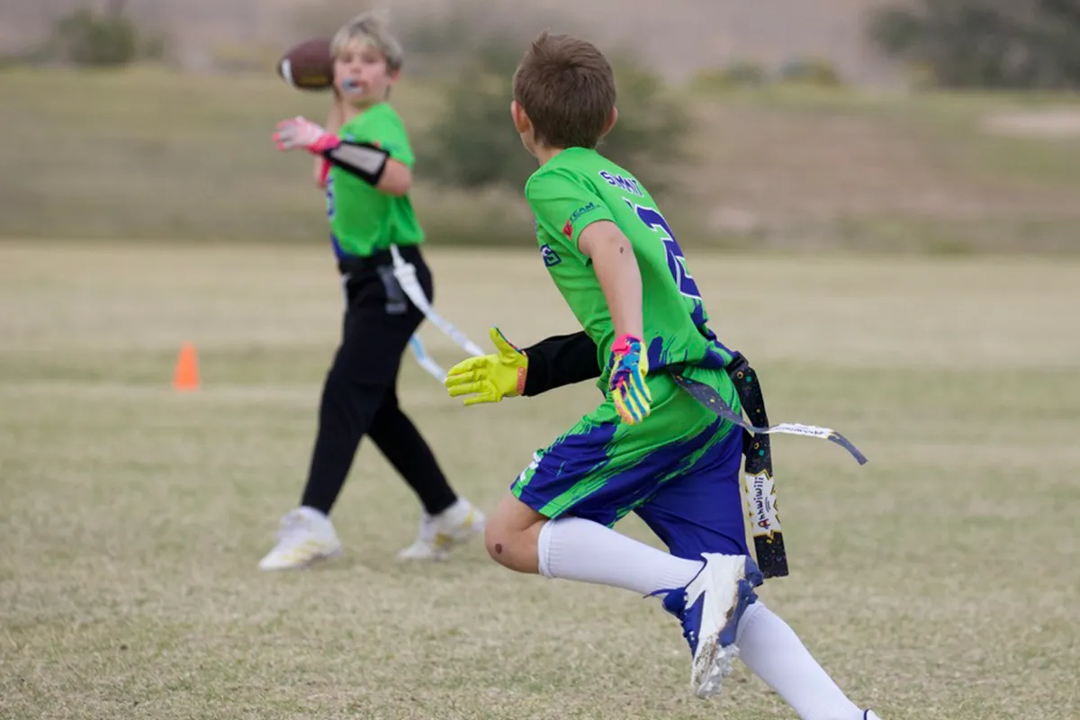 summit-school-flag-football-pass Summit School students play flag football, passing and running routes as a team.