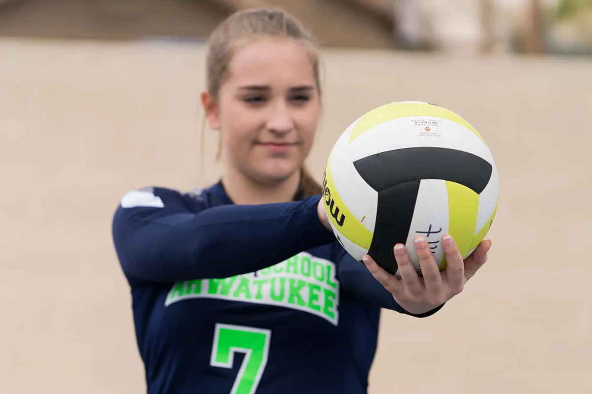 summit-school-girls-volleyball-serve Summit girls volleyball player preparing to serve the ball.