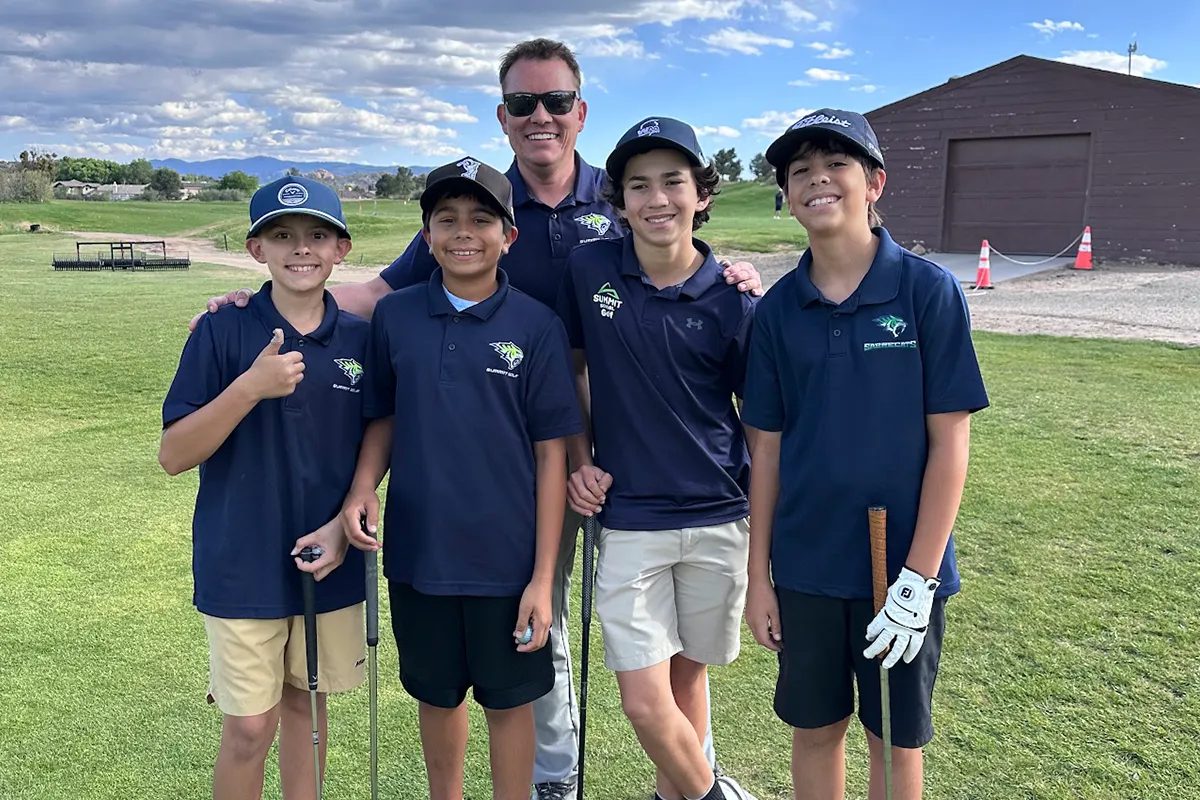 summit-school-golf-tournament Summit students with their coach at a school golf tournament.