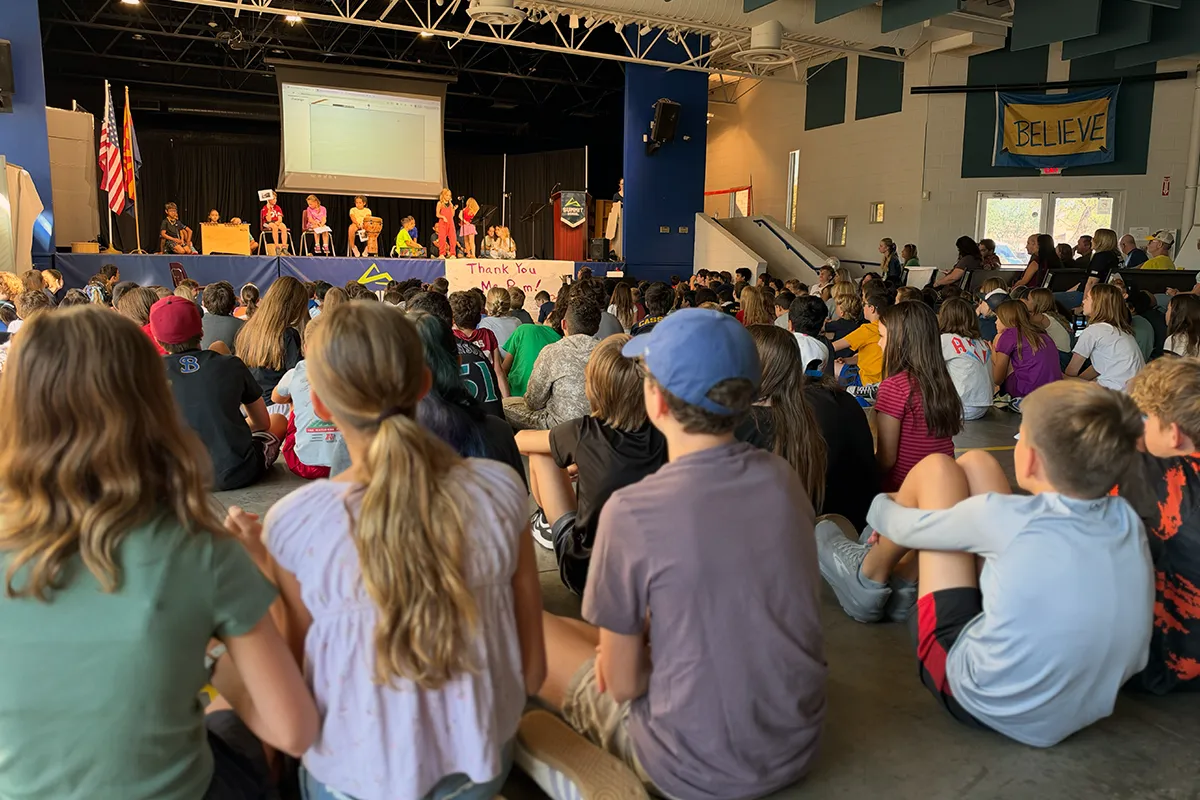 summit-school-morning-meeting-students-presenting Summit School students present on stage to the school community during Morning Meeting.