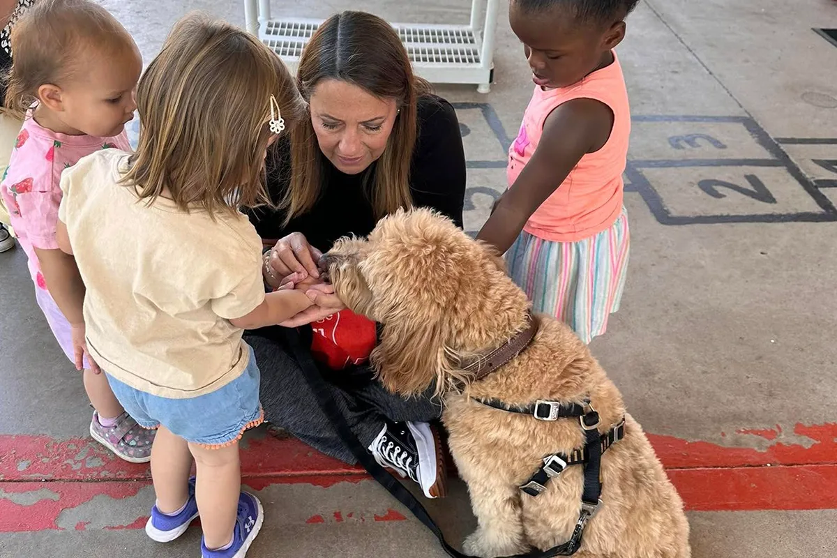 summit-school-preschool-social-emotional-learning Summit School preschool students practicing gentle interaction with a visiting therapy dog.