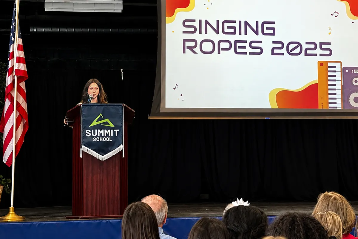 Summit School eighth-grade student presenting her ROPES project on singing.