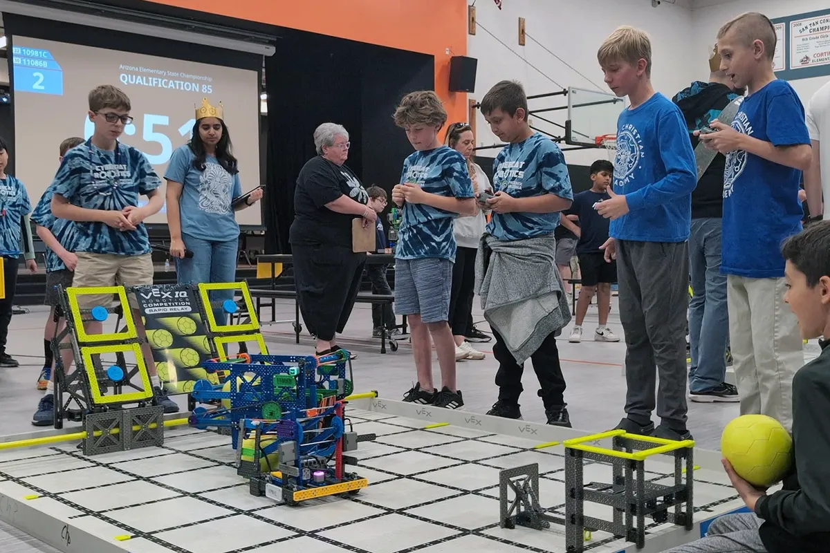 summit-school-students-robotics-competition Summit School students competing with robots at a VEX robotics competition.