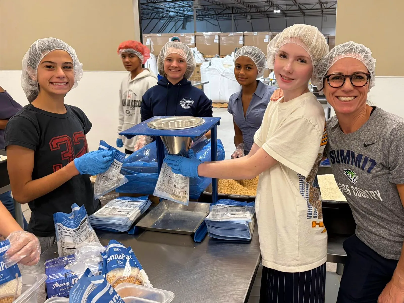 summit-serve-middle-school-community-service Summit middle school students packing food during a SERVE community service project.