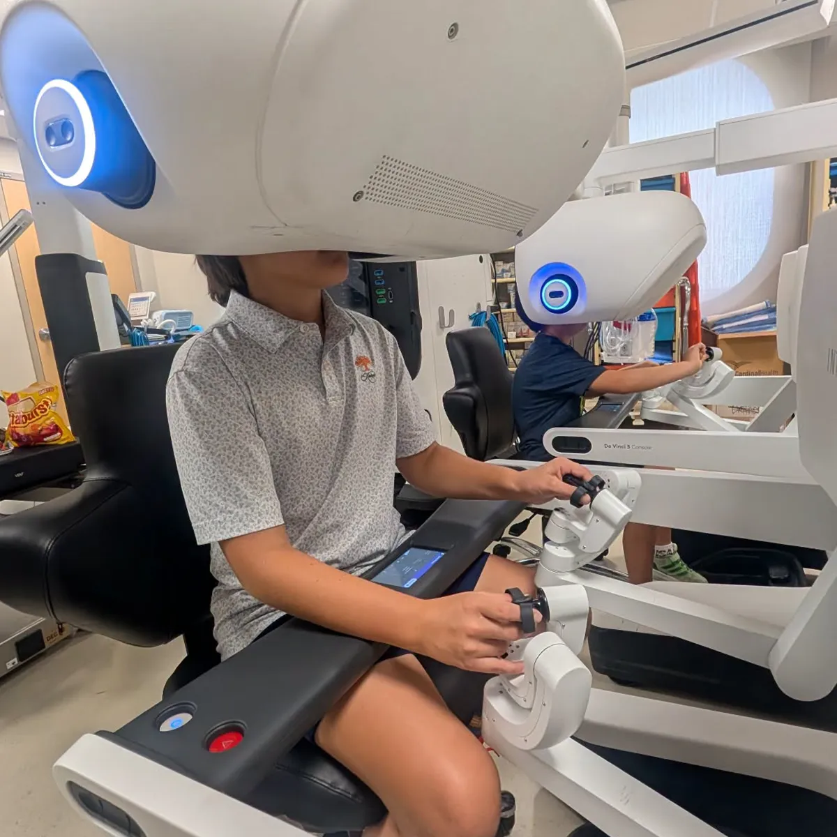 Summit School Cybercat Robotics students exploring robotic surgery technology during a STEM field trip.