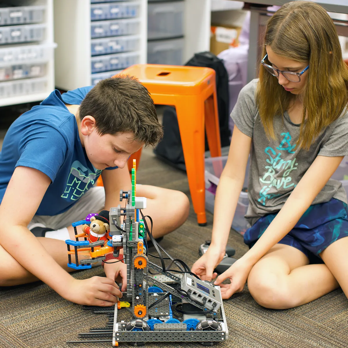 Summit School students collaborate to build and program a VEX robot, developing engineering and problem-solving skills.